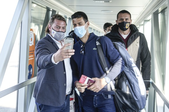 A man takes a selfie photograph with Serbian tennis player Novak Djokovic after his arrival in Belgrade, Serbia, Monday, Jan. 17, 2022. Djokovic arrived in the Serbian capital following his deportatio ...