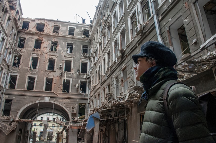 A local resident looks at his house destroyed in a Russian air raid in Kharkiv, Ukraine, Thursday, March 3, 2022. Russia's assault on Kharkiv, Ukraine's second largest city, continued Wednes ...