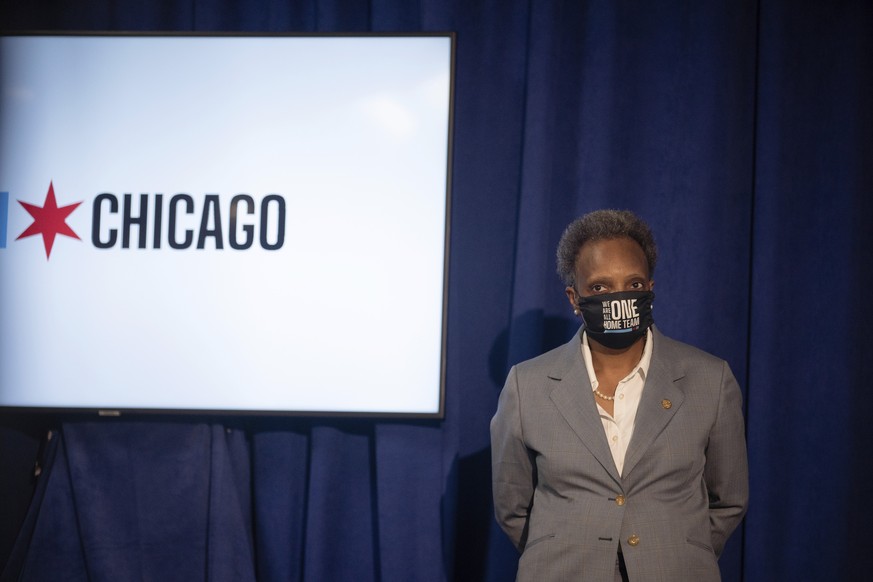 Mayor Lori Lightfoot listens during a press conference at City Hall, in Chicago, Wednesday morning, July 22, 2020, after multiple people were shot outside a funeral home in Gresham and a three-year-ol ...