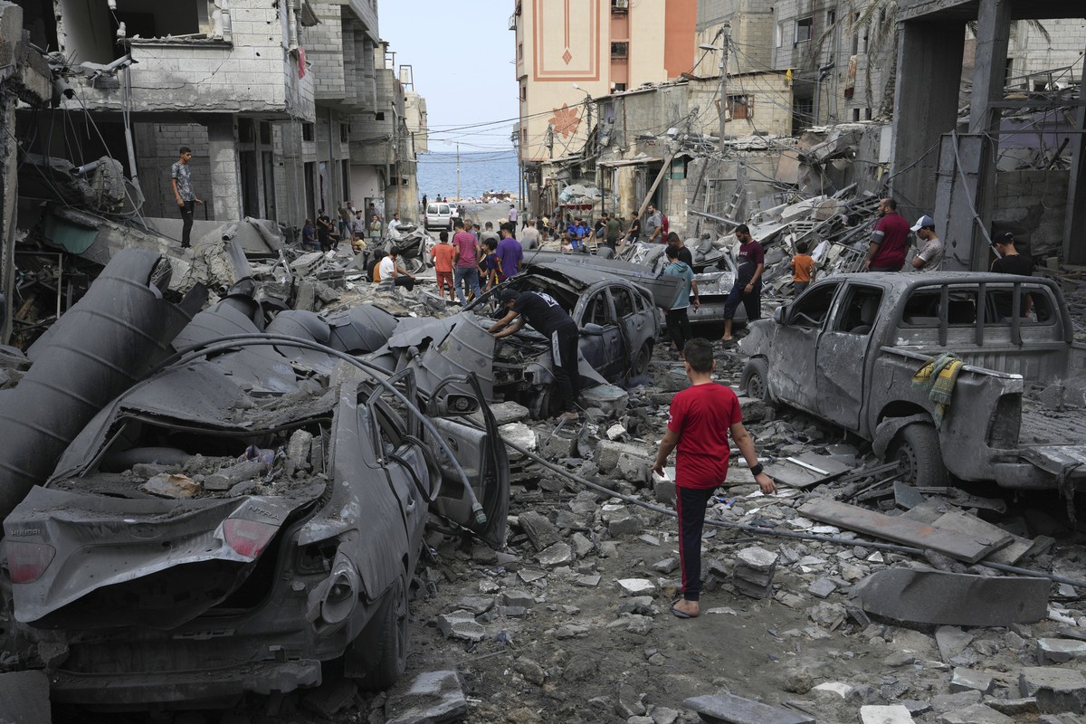 Palestinians inspect the rubble of the West mosque destroyed after it was hit by an Israeli airstrike at Shati refugee camp in Gaza City, early Monday, Oct. 9, 2023. Israel's military battled to  ...