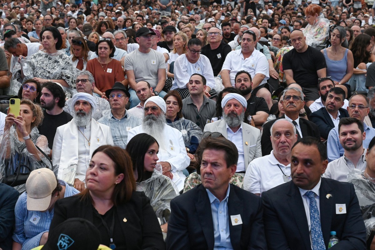 Mourners attend the memorial held for the victims of a shooting at Bondi Beach in Sydney on December 21, 2025. A father and his son are accused of spraying bullets into the family-thronged Hanukkah ce ...