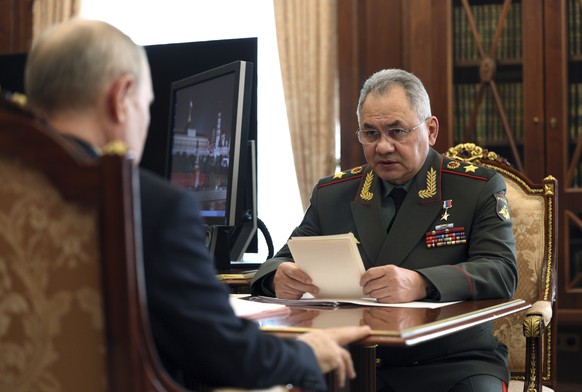 Russian President Vladimir Putin, left, and Russian Defense Minister Sergey Shoigu talk during their meeting at the Kremlin in Moscow, Russia, Monday, April 17, 2023. (Gavriil Grigorov, Sputnik, Kremlin...
