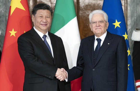 epa07455445 A handout photo made available by Quirinale Press Office shows Chinese President Xi Jinping (L) shaking hands with Italian President Sergio Mattarella (R) at the Quirinale Presidential Pal ...