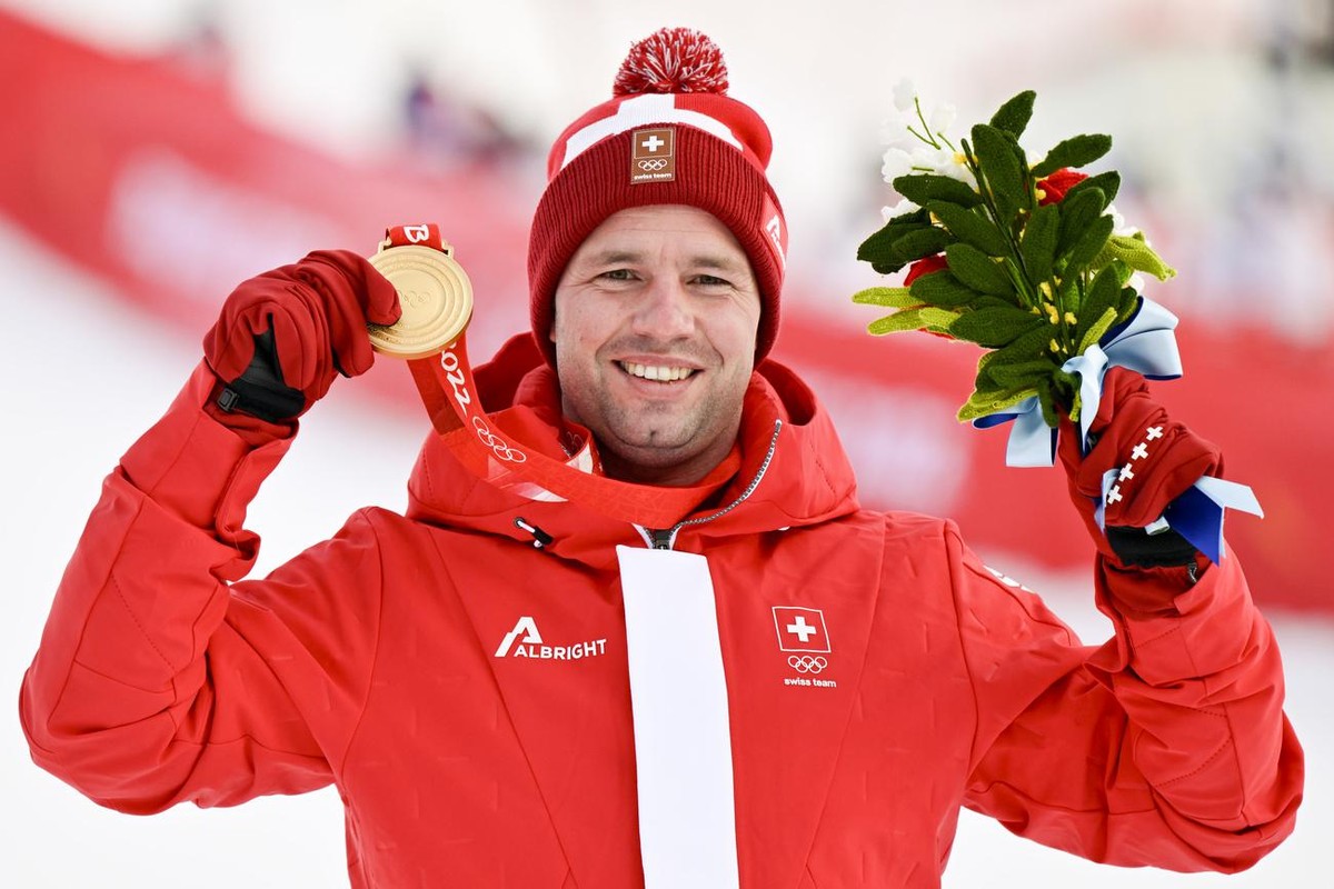 Gold medalist Beat Feuz of Switzerland celebrates during the victory ceremony of the men's Alpine Skiing downhill race at the 2022 Olympic Winter Games in Yanqing, China, on Monday, February 7, 2 ...