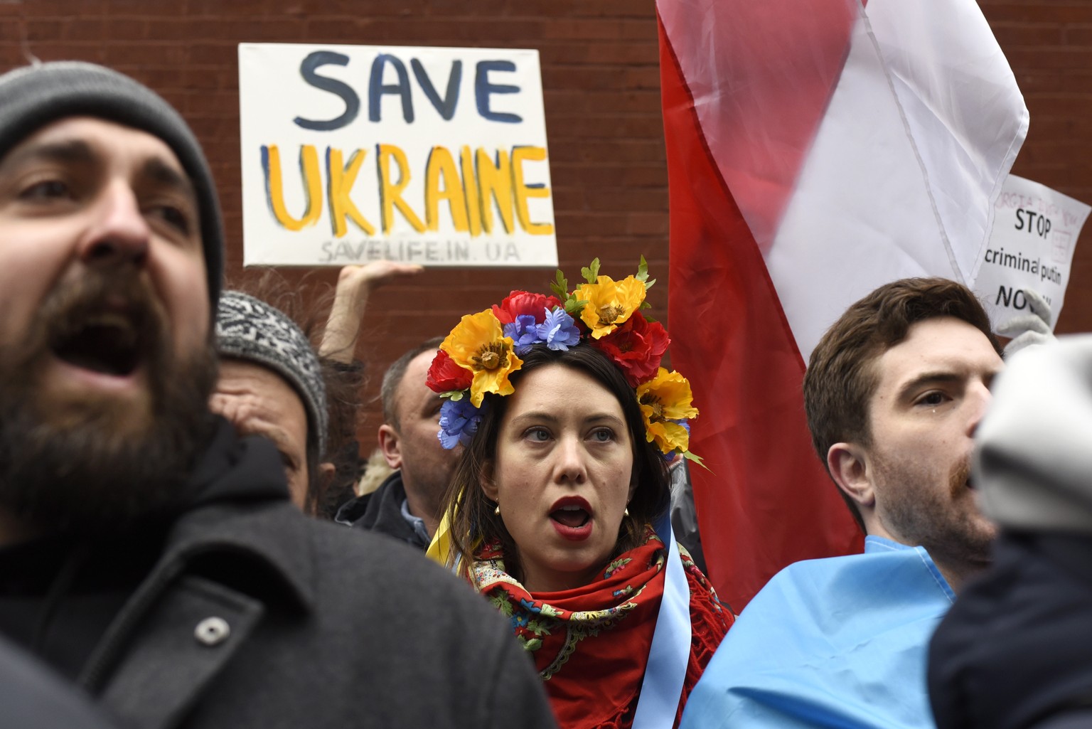 epa09782514 A person wearing a Ukrainian wreath chants, &#039;Stop Putin now,&#039; with the crowd during a protest outside the Permanent Mission of the Russian Federation in New York, New York, USA,  ...