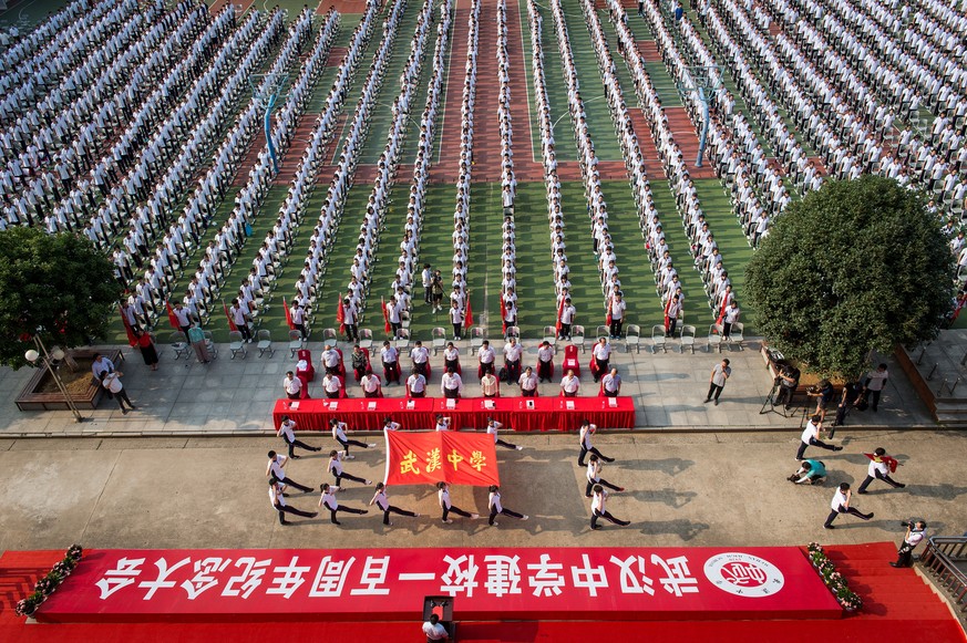 epa08638846 Students of Wuhan High School sit as they attend the ceremony for the new fall semester in Wuhan, Hubei Province, China, 01 September 2020. Wuhan, the city at the epicenter of the coronavi ...