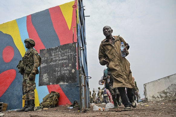 Government soldiers and police officers, at right, who surrendered to M23 rebels, left, board trucks to an undisclosed location in Goma, Democratic republic of the Congo, Thursday, Jan. 30, 2025. (AP  ...