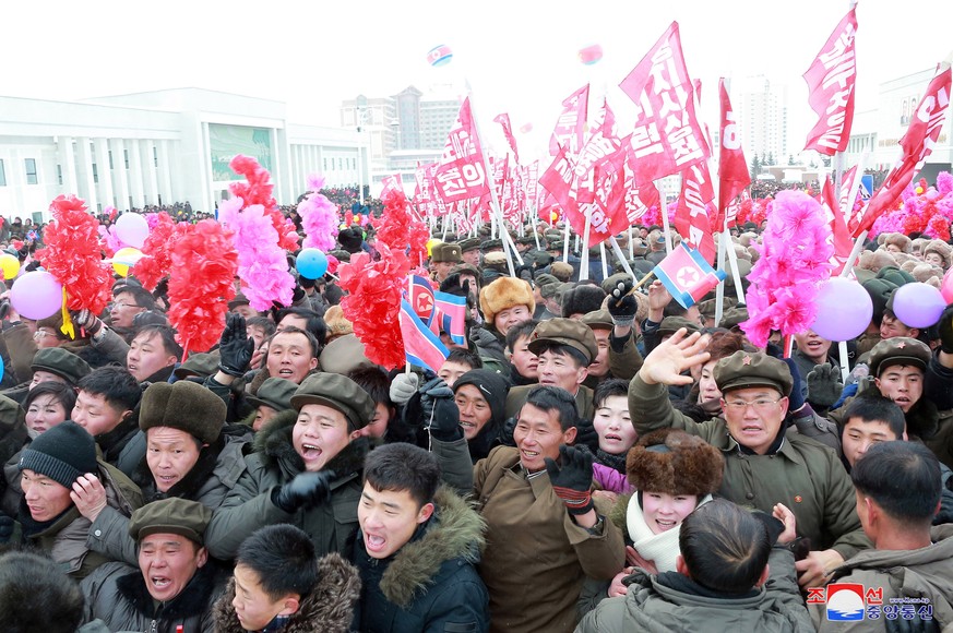 epa08040321 A photo released by the official North Korean Central News Agency (KCNA) shows citizens attending a ribbon-cutting ceremony to open a Township of Samjiyon County, North Korea, 02 December  ...