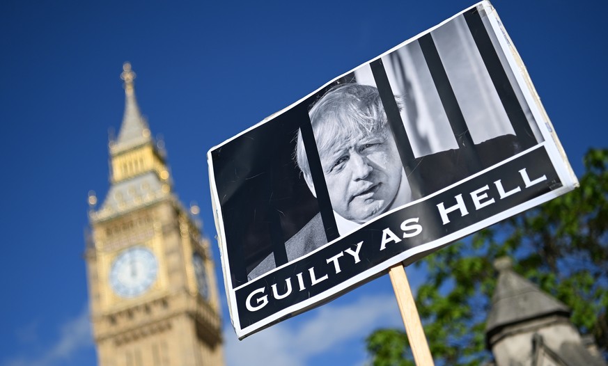epa09975097 A protester demonstrates against the Downing Street parties, outside parliament in London, Britain, 25 May 2022. British Prime Minister Boris Johnson is under pressure over 'party gate' al ...