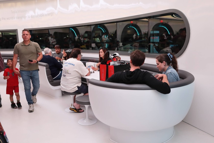 LOS ANGELES, CA - JULY 21: People dine inside the Tesla Diner and Drive-In restaurant and Supercharger on July 21, 2025 in Los Angeles, California. The futuristic Tesla Diner and supercharger station  ...