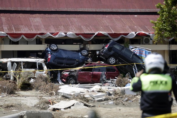 epa07062765 Numerous automobiles are piled on top of each other after a structure collapsed during an earthquake and tsunami, in Palu, Central Sulawesi, Indonesia, 02 October 2018. According to report ...