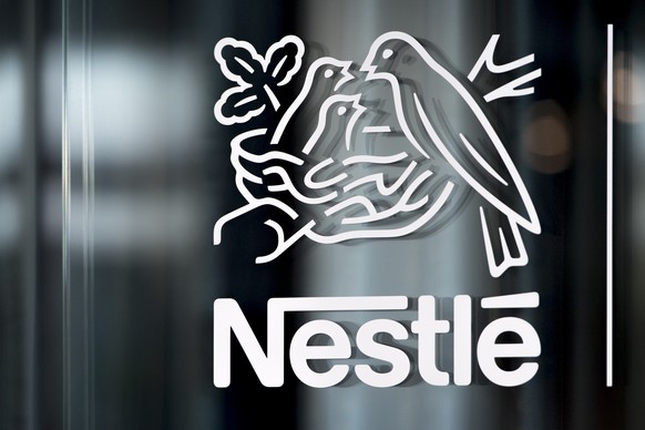 FILE - Nestle&#039;s logo is displayed on a window, during the 2018 full-year results press conference of the food and drinks giant Nestle, in Vevey, Thursday, Feb. 14, 2019. Global food giant Nestle, ...
