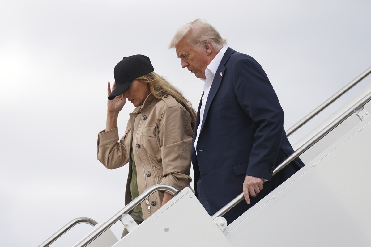 President Donald Trump, right, and first lady Melania Trump arrive on Air Force One at Kelly Field air base in San Antonio, Texas, en route to observe flood damage in Kerrville, Texas, Friday, July 11 ...