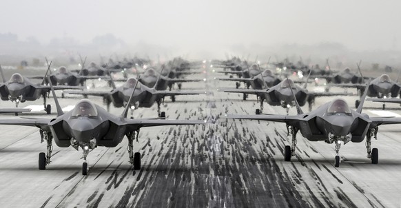 In this photo provided by South Korea Defense Ministry via Yonhap News Agency, South Korean Air Force's F-35A stealth fighters perform an elephant walk at an unidentified air base, South Korea, F ...