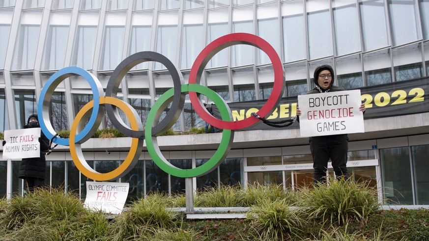 Protesters hold Tibetan flags during a protest against Beijing 2022 Winter Olympics by activists of the Tibetan Youth Association in Europe front of the International Olympic Committee, IOC, headquart ...