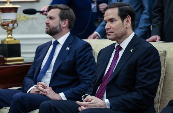epa12437905 US Secretary of State Marco Rubio (R), and US Vice president JD Vance (L) look on as President Donald Trump meets with Canadian Prime Minister Mark Carney in the Oval Office of the White H ...