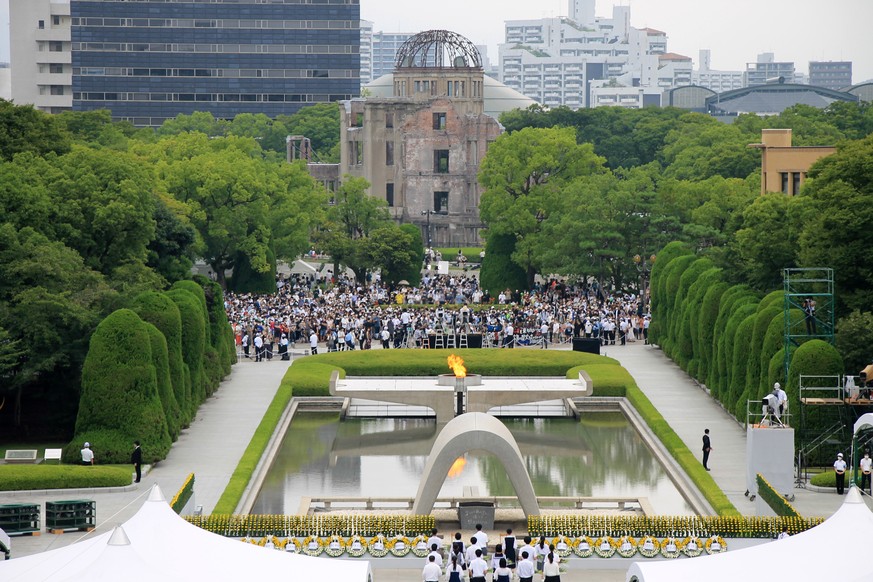 epa10108179 People gather during a ceremony at Peace Memorial Park in Hiroshima, western Japan, 06 August 2022. On 06 August 2022, Japan marked the 77th anniversary of the bombing of Hiroshima. EPA/JI ...