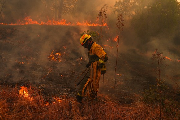 FILE - A firefighter carries a hose while battling a wildfire in San Martin de Valdeiglesias, west of Madrid, Spain, July 26, 2026. (AP Photo/Manu Fernandez, File)
Climate Europe Wildfires Worsening