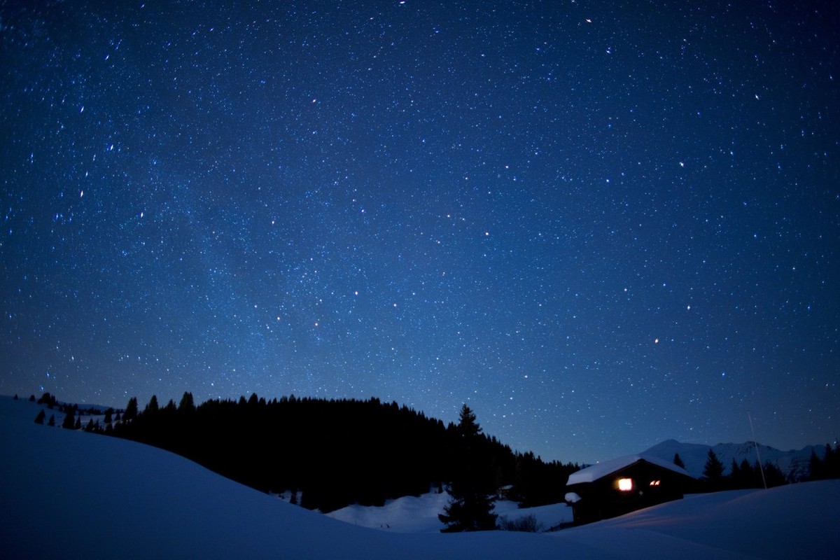 Stars shine above a house on the golf course in Arosa, Switzerland, late Friday, February 8, 2008. Arosa lies on 1800 Meter above sea level and is surrounded by mountains. This makes it an ideal place ...