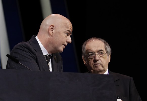 FILE - In this Wednesday, June 5, 2019 file photo, FIFA President Gianni Infantino, left, speaks with French Football Federation President Noel Le Graet before the start of the 69th FIFA congress in P ...