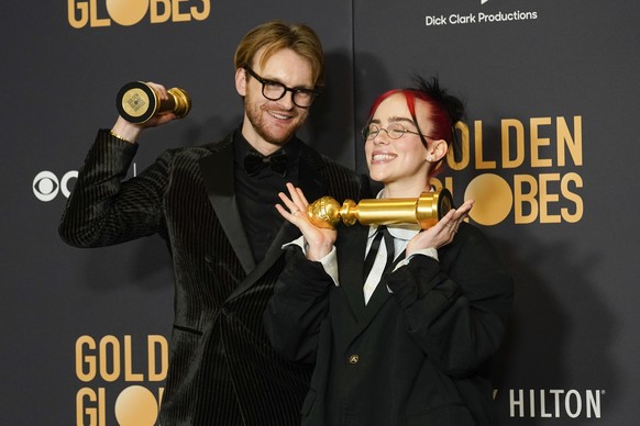 Finneas, left, and Billie Eilish pose in the press room with the award for best original song, motion picture for &quot;What Was I Made For?&quot; from &quot;Barbie&quot; at the 81st Golden Globe Awar ...
