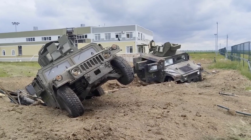 epa10648879 A still image taken from a handout video made available by the Russian Defence Ministry Press-Service shows destroyed armored fighting vehicles in the Grayvoronsky district of Belgorod reg ...