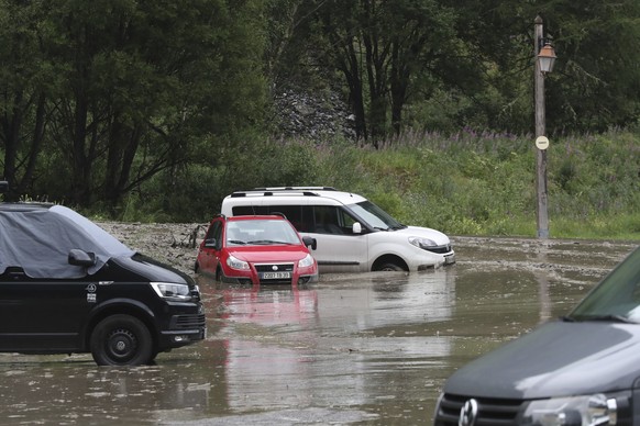 cars are trapped in a flooded street near the road of the nineteenth stage of the Tour de France cycling race over 126,5 kilometers (78,60 miles) with start in Saint Jean De Maurienne and finish in Ti ...