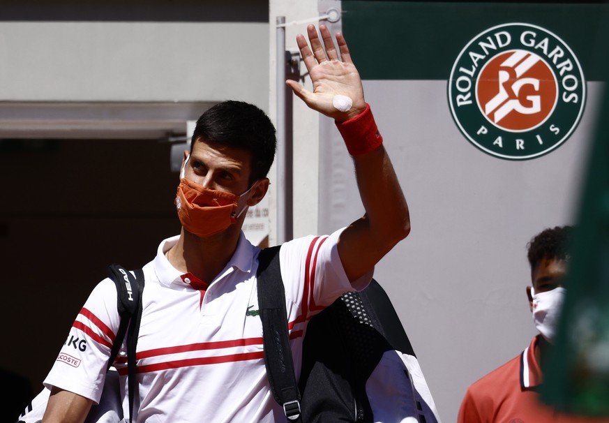 epa09267006 Novak Djokovic of Serbia, weraing a protective face mask, arrives for the final match against Stefanos Tsitsipas of Greece at the French Open tennis tournament at Roland Garros in Paris, F ...