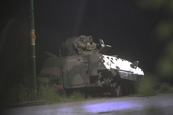 Armed Zimbabwean soldiers sit on top of a military tank in Harare, Zimbabwe Wednesday, Nov. 15, 2017. At least three explosions were heard in Zimbabwe&#039;s capital early Wednesday and military vehic ...