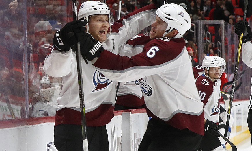 Colorado Avalanche center Nathan MacKinnon, left, celebrates his goal against the Detroit Red Wings with Erik Johnson (6) in overtime of an NHL hockey game, Sunday, Nov. 19, 2017, in Detroit. Colorado ...