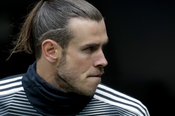 Real Madrid's Gareth Bale sits on the bench before the start of a Spanish La Liga soccer match between Real Madrid and Betis at the Santiago Bernabeu stadium in Madrid, Spain, Sunday, May 19, 2019. (A ...