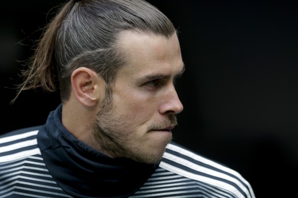 Real Madrid&#039;s Gareth Bale sits on the bench before the start of a Spanish La Liga soccer match between Real Madrid and Betis at the Santiago Bernabeu stadium in Madrid, Spain, Sunday, May 19, 201 ...