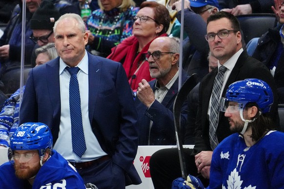 Toronto Maple Leafs head coach Craig Berube and new assistant coach Steve Sullivan look on during the first period of an NHL hockey game against the Ottawa Senators in Toronto, Saturday, Dec. 27, 2025 ...