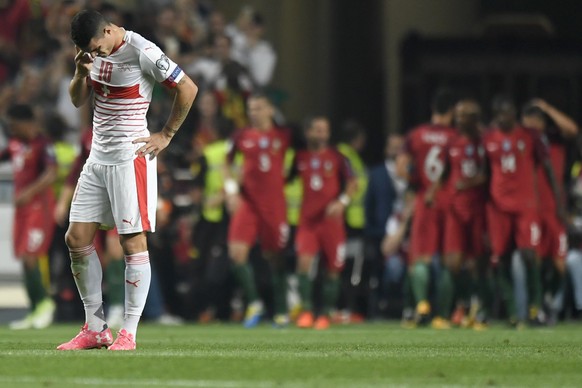 epa06257657 Switzerland&#039;s Granit Xhaka, left, reacts while the Portuguese players celebrate their second goal during the 2018 Fifa World Cup Russia group B qualification soccer match between Port ...