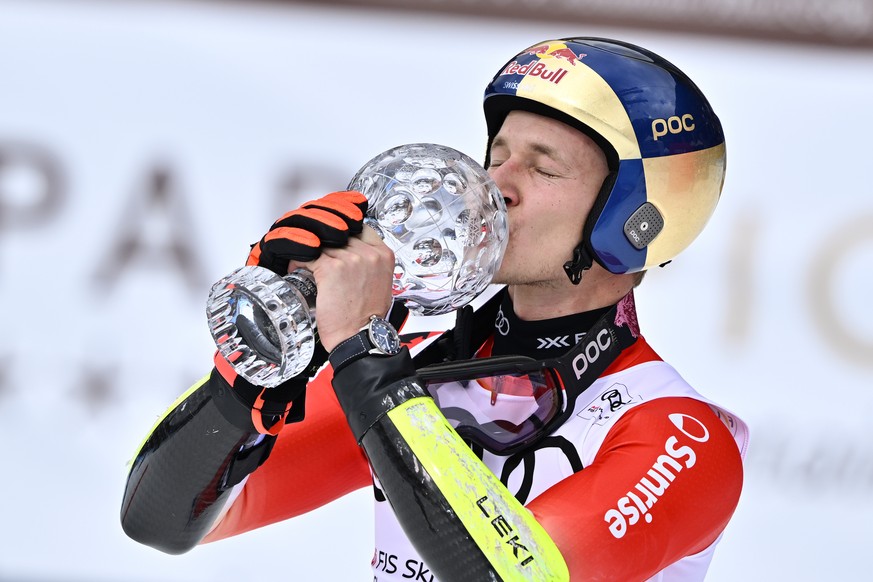 Marco Odermatt of Switzerland celebrates with the men&#039;s giant slalom overall leader crystal globe trophy in the finish area during the men&#039;s giant slalom race at the FIS Alpine Skiing World  ...