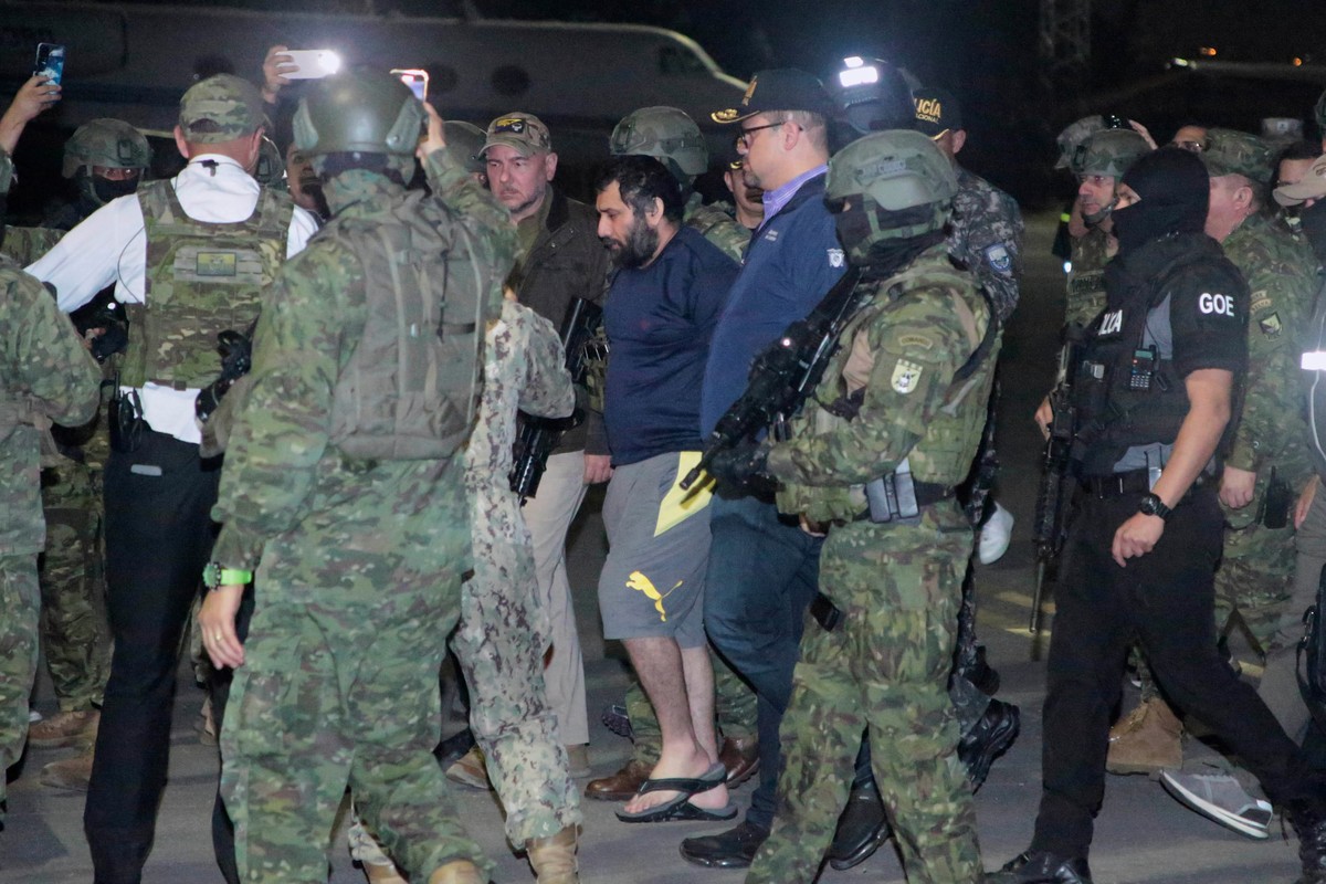 Escorted by soldiers and police officers, Adolfo "Fito" Macias, the leader of the Choneros gang, arrives in Guayaquil, Ecuador, after getting detained, Wednesday, June 25, 2025. (AP Photo/Jo ...