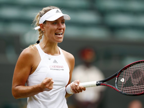 epa06071100 Angelique Kerber of Germany scores a winner against Kristen Flipkens of Belgium in their second round match during the Wimbledon Championships at the All England Lawn Tennis Club, in Londo ...