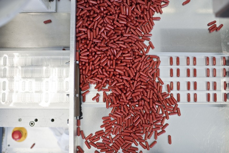A machine dispenses pharmaceutical capsules into blister packs, pictured on February 1, 2010 at the manufacturing and logistics facility of pharmaceutical company Acino Holding AG in Aesch in the cant ...