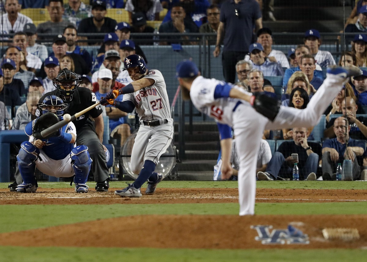 epa06289813 Houston Astros batter Jose Altuve hits a solo home run off Los Angeles Dodgers relief pitcher Josh Fields iin the tenth inning of Major League Baseball's (MLB) World Series game two a ...