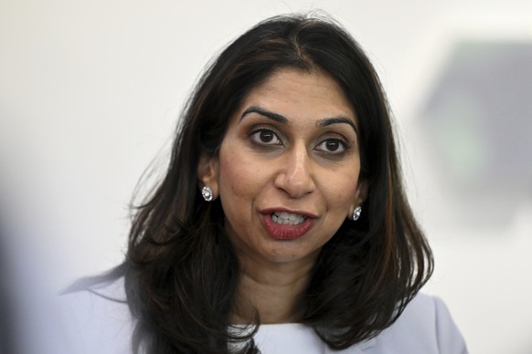 FILE - Britain&#039;s Home Secretary Suella Braverman speaks to volunteers during a visit to Bolton Lads and Girls Club in Bolton, Greater Manchester, Tuesday Oct. 3, 2023, on the sidelines of the ann ...