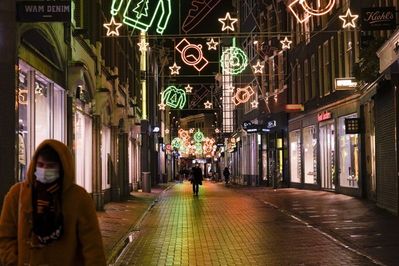 FILE - A view of the capital&#039;s shopping streets are near-empty after 5 pm in Amsterdam, Netherlands, Monday, Nov. 29, 2021, after a tougher COVID-19 related lockdown came into effect. The new Dut ...