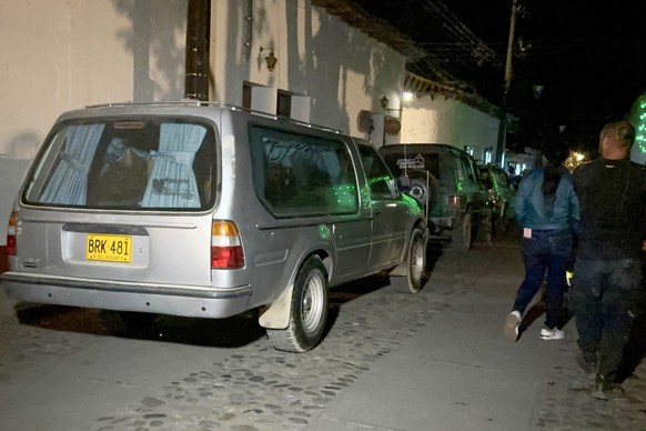 epa12689722 A view of the hearses site where the first bodies recovered from a plane crash arrived in a rural area of the municipality of La Playa de Belen, Colombia, 28 January 2026. All 15 people on ...