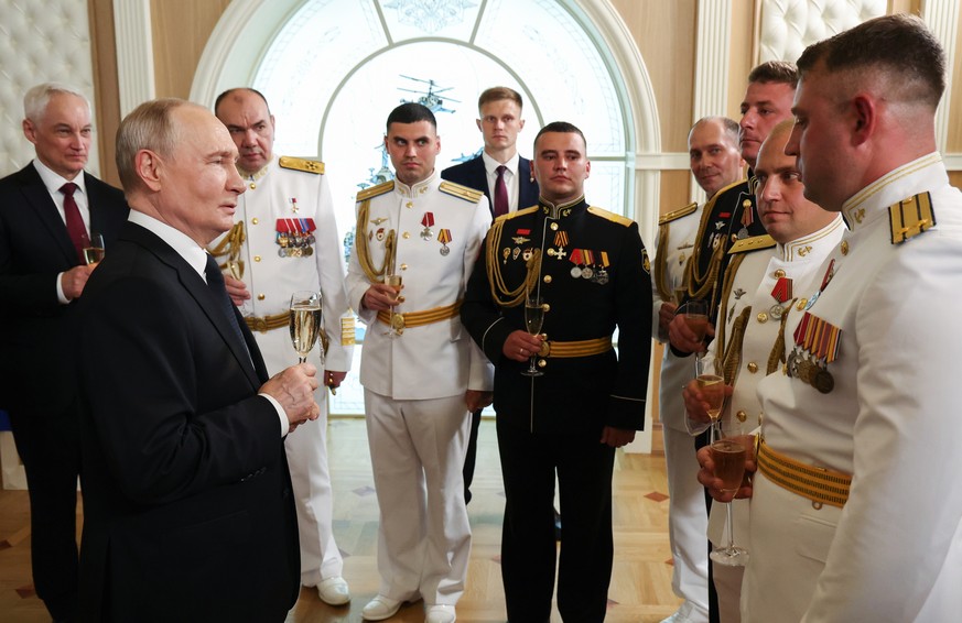 epa13134773 Russian President Vladimir Putin (2-L), accompanied by Defence Minister Andrei Belousov (L) and Commander-in-Chief of the Russian Navy Admiral Alexander Moiseev (3-L), meets with recipient ...