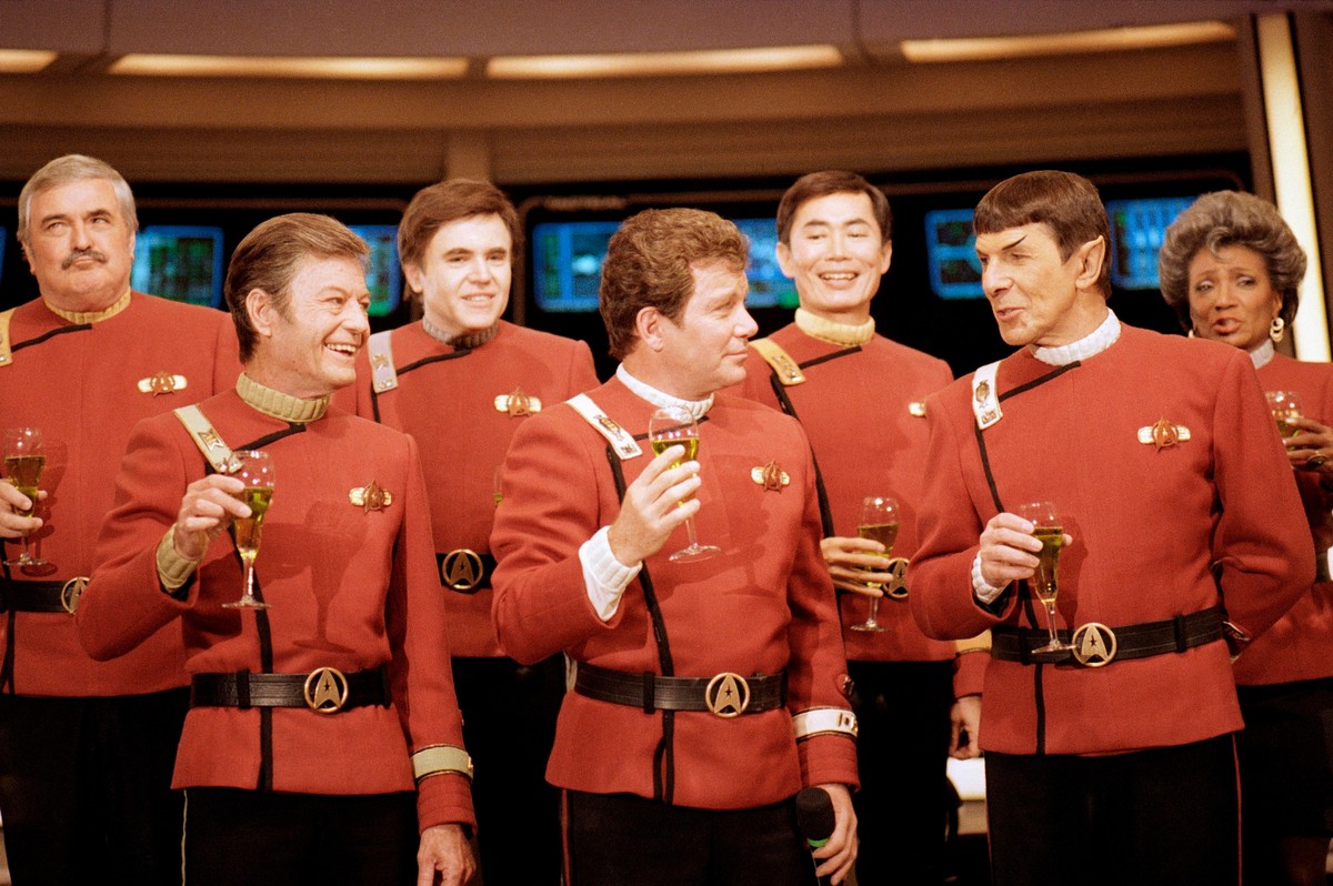 FILE- Members of the "Star Trek" crew, from left, James Doohan, DeForest Kelley, Walter Koenig, William Shatner, George Takei, Leonard Nimoy, and Nichelle Nichols, toast the newest "Sta ...
