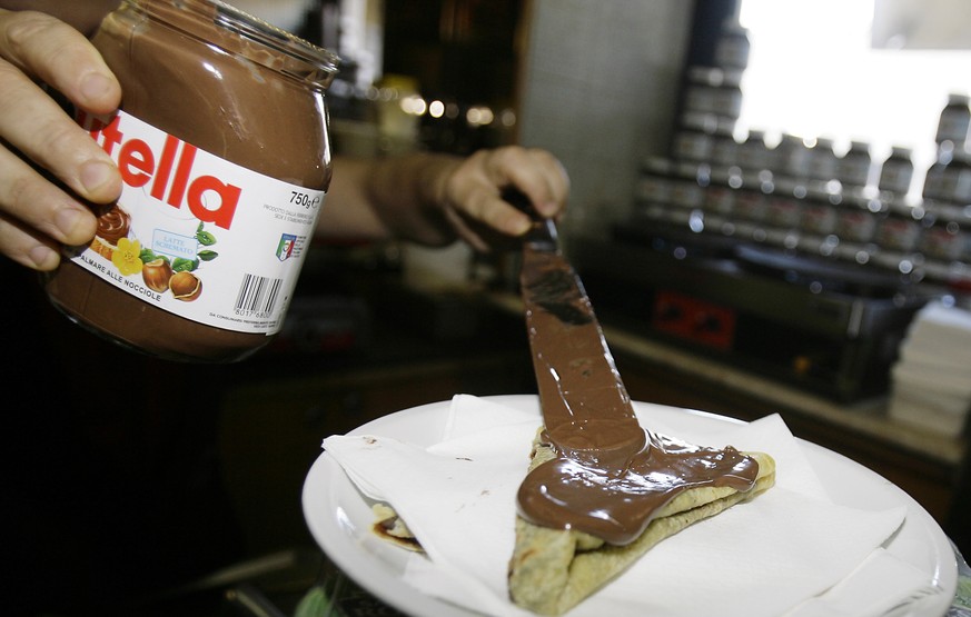 FILE - In this June 18 2010 file photo,a bartender spreads Nutella on a crepe in a creperie in Rome. French workers frustrated over salary negotiations are blocking the world&#039;s biggest Nutella fa ...