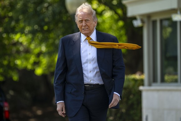 epa12951616 President Donald Trump walks to speak to the press before departing the White House for China, in Washington, DC, USA, 12 May 2026. President Trump is leaving the US to visit China where h ...