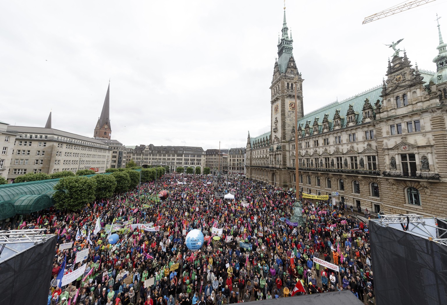 Participants of the demonstration &#039;G20 Protest Wave&#039; gather in front of the city hall in Hamburg, Germany, Sunday, July 2, 2017 to protest againt the upcoming G20 summit on July 7 and July 8 ...