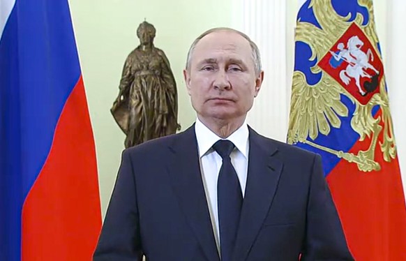 In this handout photo made from video released by the Russian Presidential Press Service, Russian President Vladimir Putin speaks to celebrate International Women&#039;s Day, in Moscow, Russia, Tuesda ...
