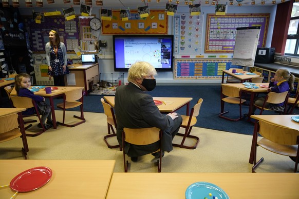 Britain&#039;s Prime Minister Boris Johnson joins a Year 2 maths lesson during a visit to St Mary&#039;s Primary School at Stoke-on-Trent, England, Monday March 1, 2021. The children of key workers ar ...