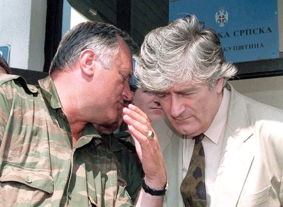 epa08529962 (FILE) - Republika Srpska leader Radovan Karadzic (R) listens to VRS Commander Ratko Mladic (L) during a meeting in Pale, Bosnia and Herzegovina, 05 August 1993 (reissued 06 July 2020). A  ...